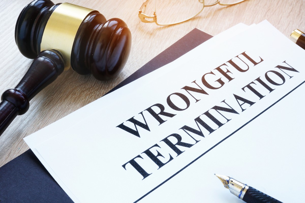 Wooden gavel and paper that reads wrongful termination